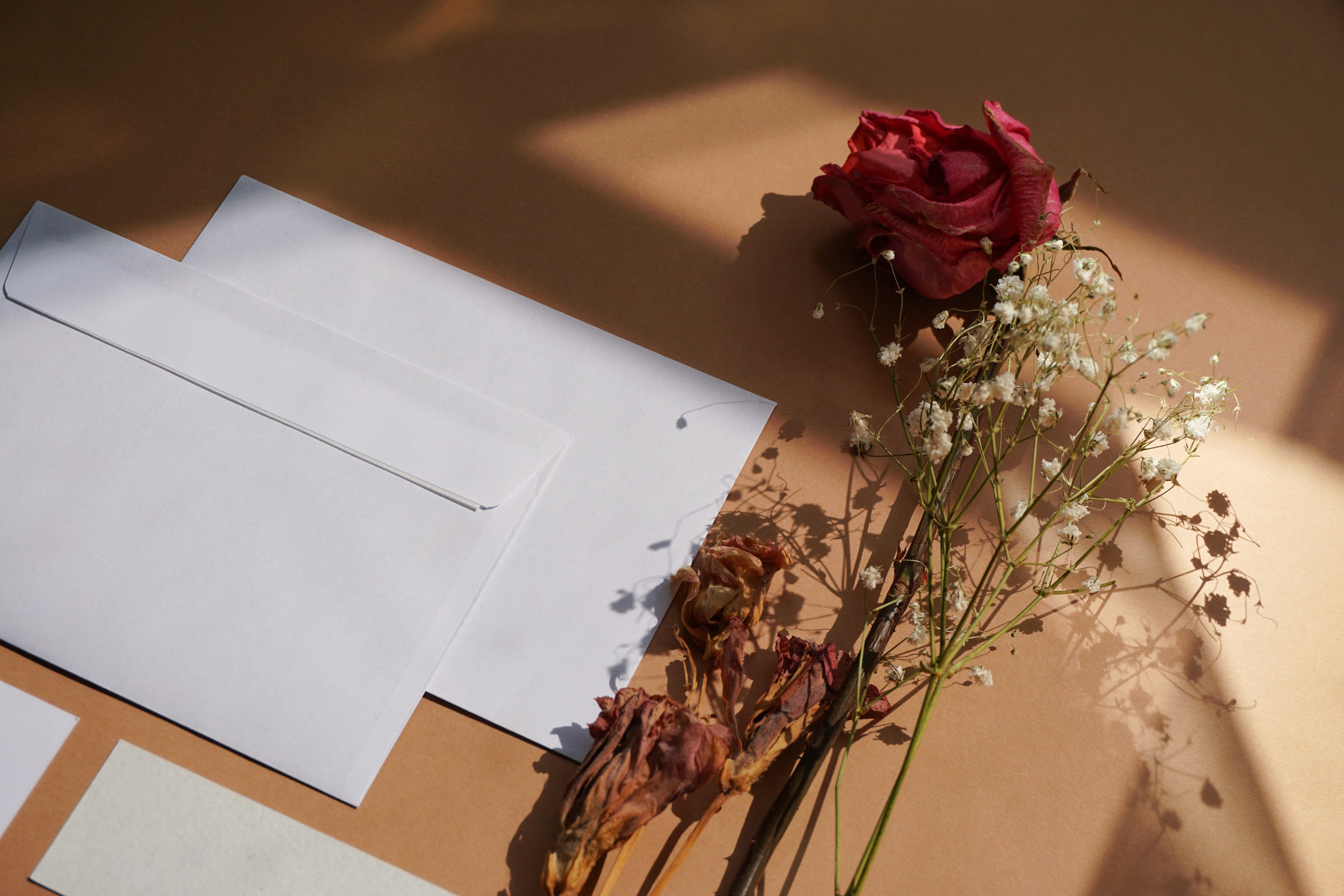 Flat lay of bespoke wedding invitations and envelopes